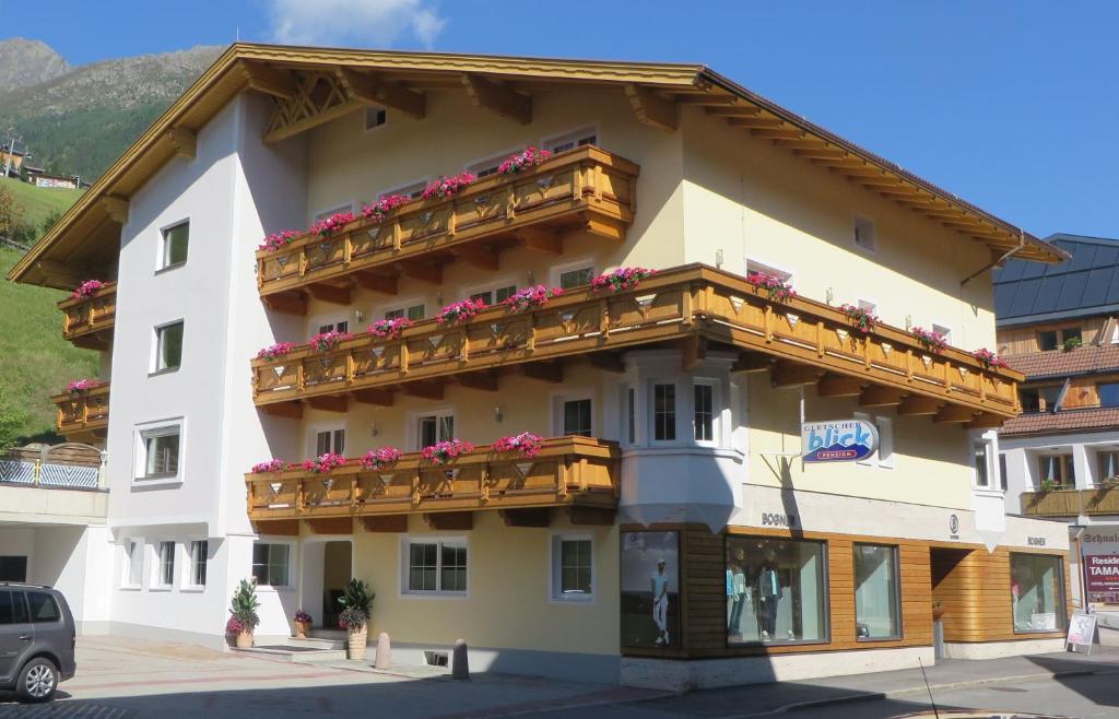 a building with balconies and flowers on it at Apart Gletscherblick in Sölden
