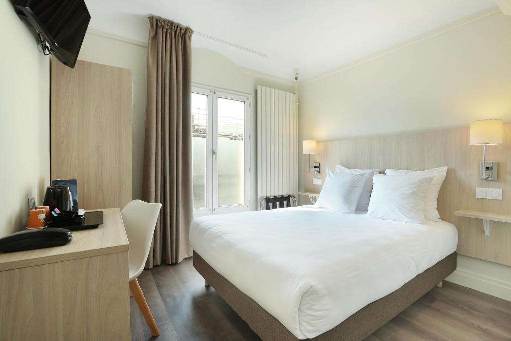 a hotel room with a large bed and a window at Murat in Paris