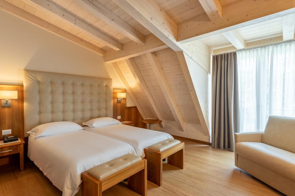 Postel nebo postele na pokoji v ubytování Hotel Palme & Suite