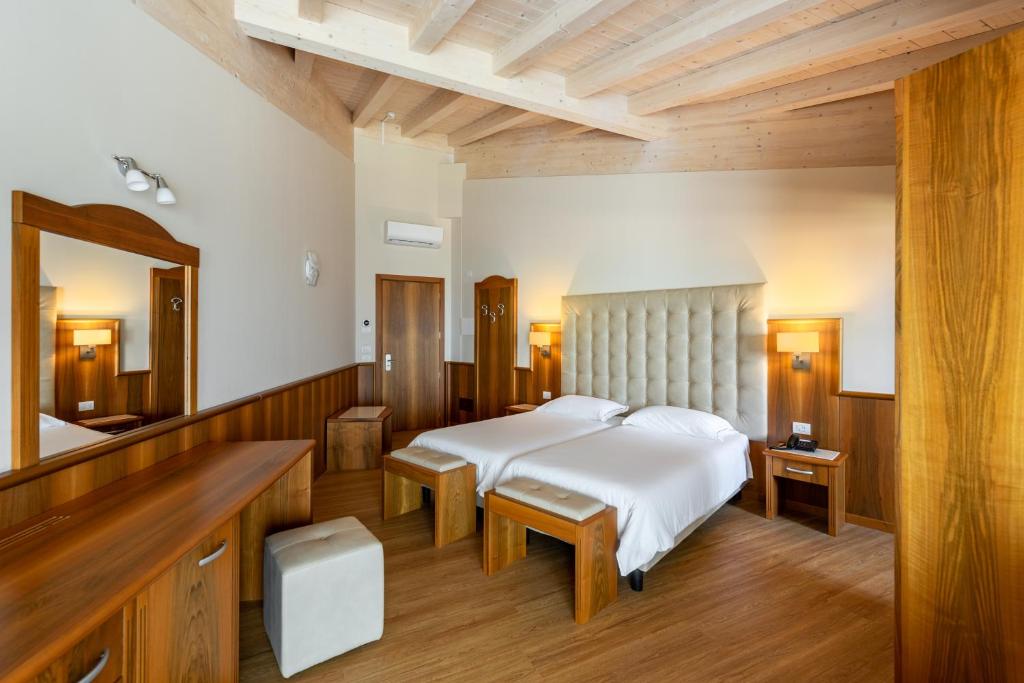 Postel nebo postele na pokoji v ubytování Hotel Palme & Suite