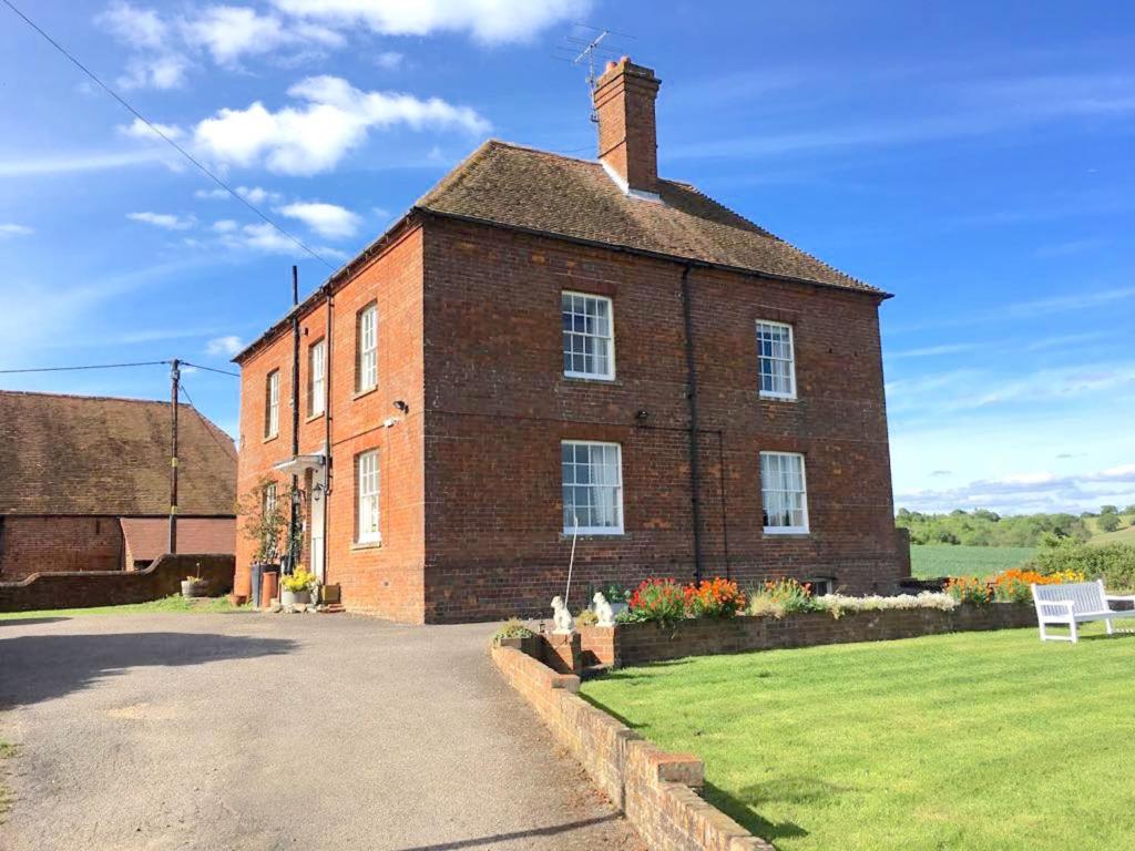 a large brick building with a lawn in front of it at Colthrop Manor with Gardens in Thatcham