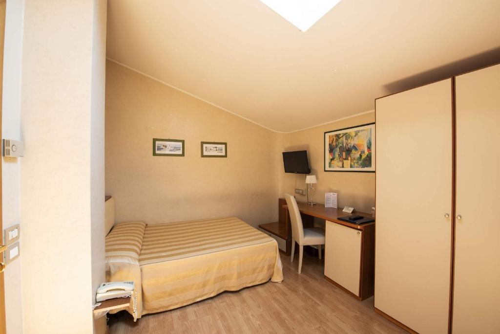 Postel nebo postele na pokoji v ubytování Hotel Cristoforo Colombo