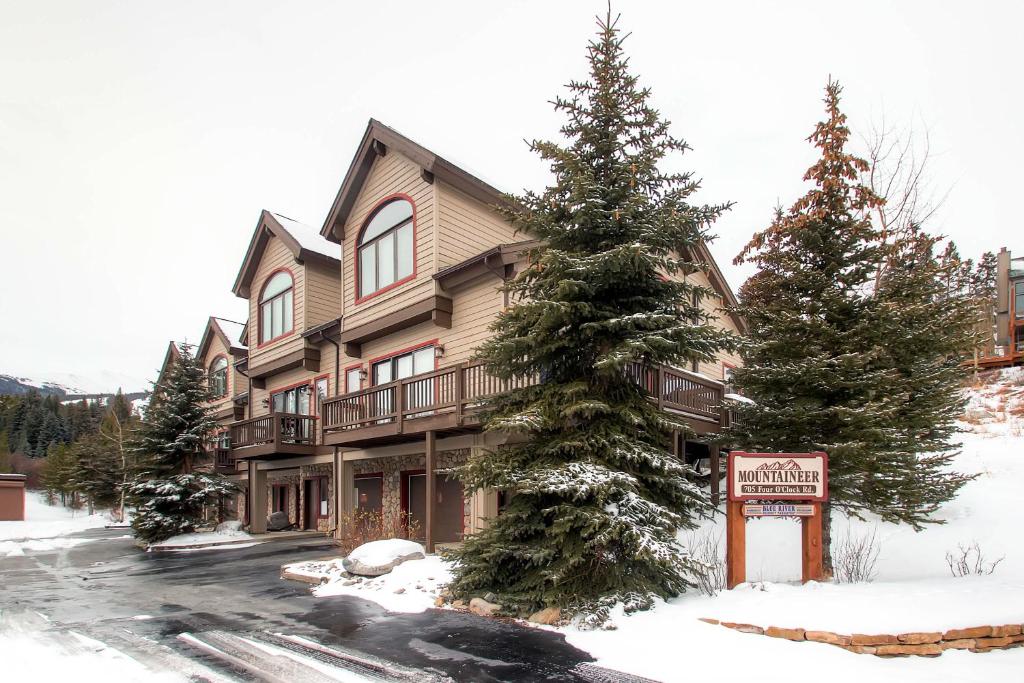 a large building with a sign in the snow at Mountaineer #M-1 - Ski-In/Ski-Out - Private Outdoor Hot Tub in Breckenridge