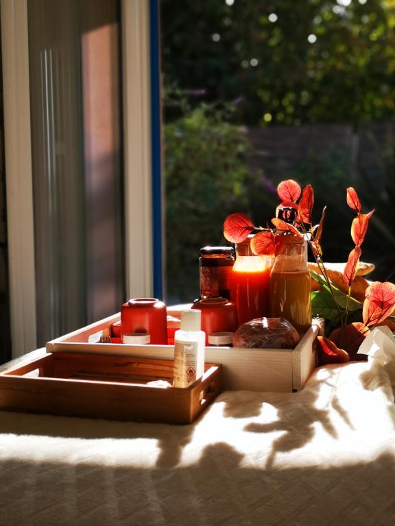 a tray with cosmetics and a candle on a table at OH ! MADIANA in Saint-Jean-dʼIllac