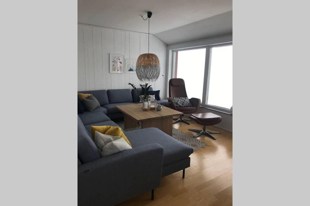 a living room with a blue couch and a table at 4 bedroom apartment at Riksgränsen in Riksgränsen