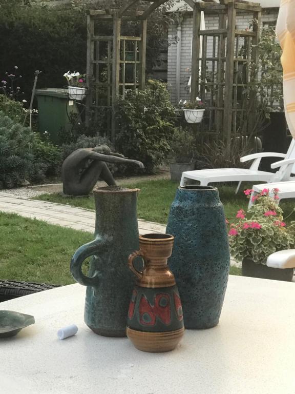 three vases sitting on top of a table at Villa 't Haasduin in Wijk aan Zee