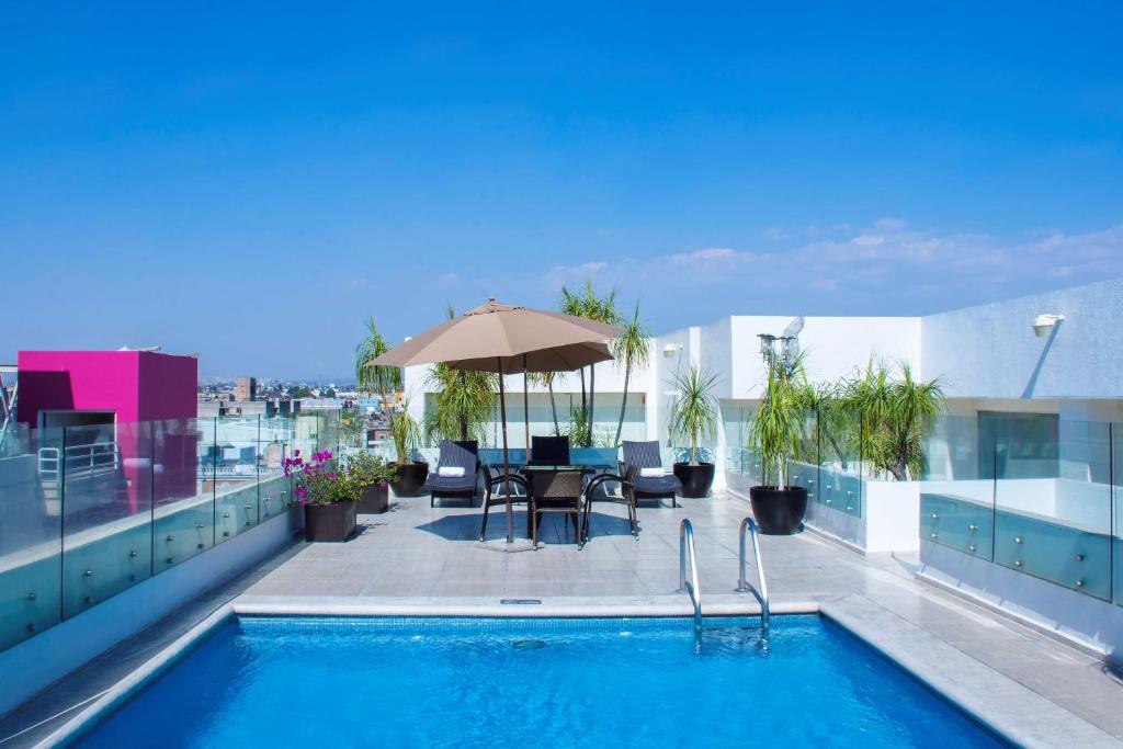 a swimming pool on the roof of a building at NH Puebla Centro Histórico in Puebla