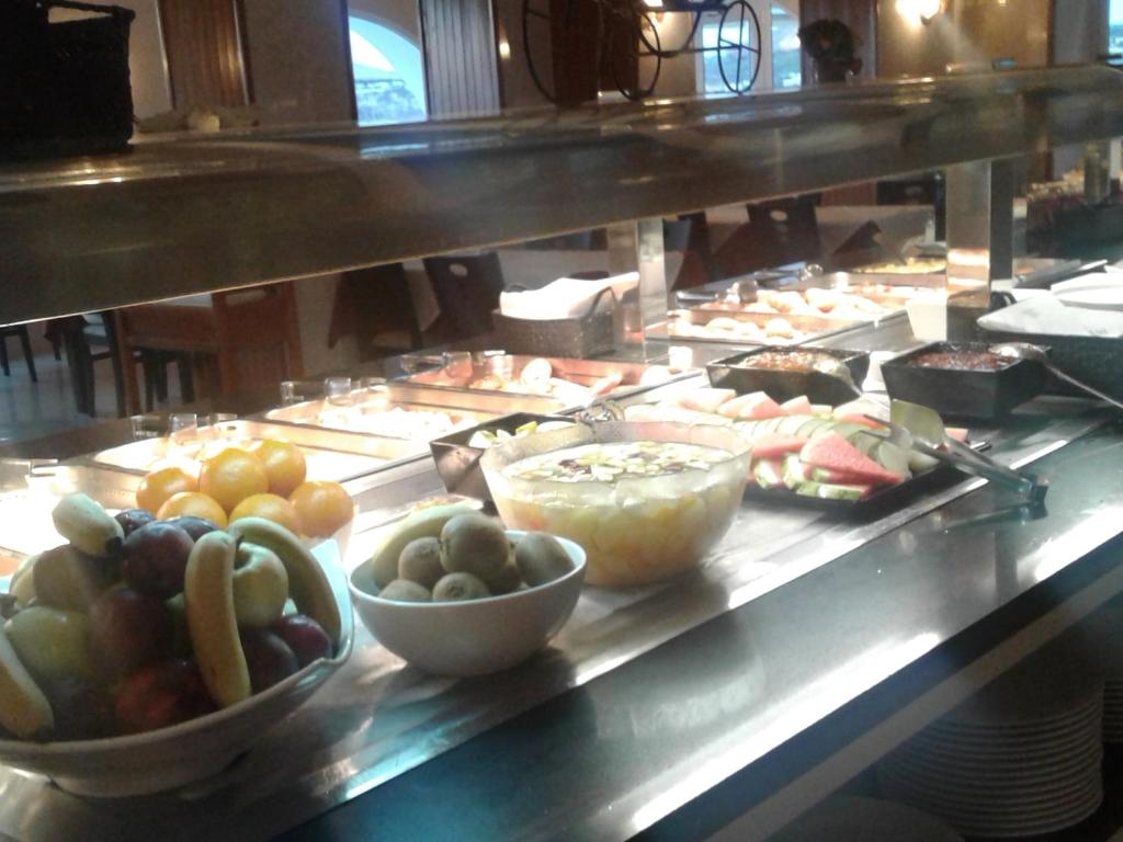 a buffet line with many different types of food at Hotel Roca Bella in Es Pujols