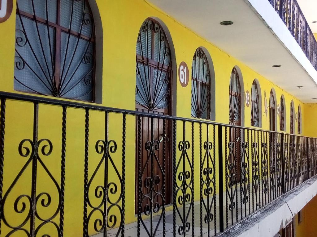 eine Reihe von Türen an einer gelben Wand in der Unterkunft H MEXICANA DE MÁRMOL in Tehuacán