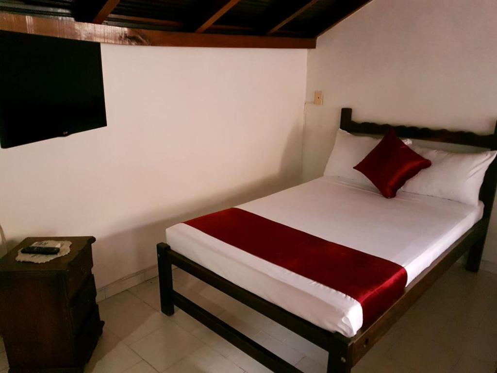 Postel nebo postele na pokoji v ubytování Hotel Don Juan Colonial