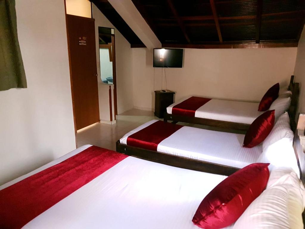 Postel nebo postele na pokoji v ubytování Hotel Don Juan Colonial