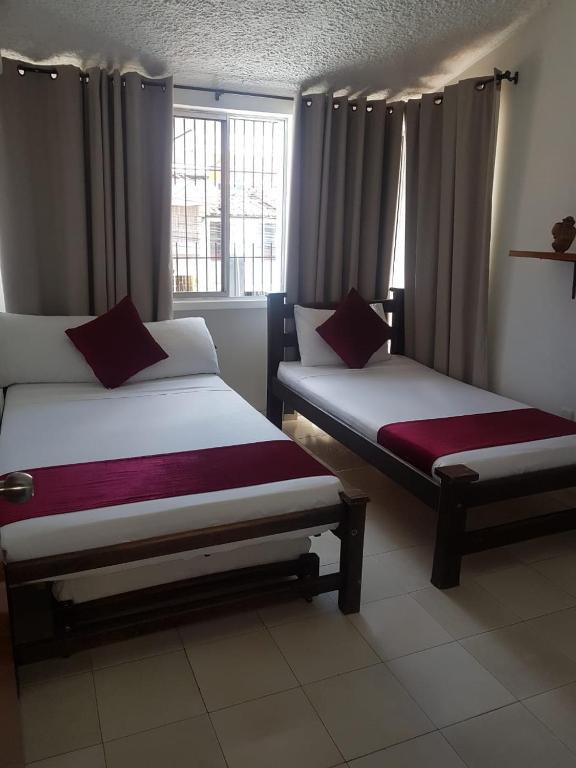 Postel nebo postele na pokoji v ubytování Hotel Don Juan Colonial