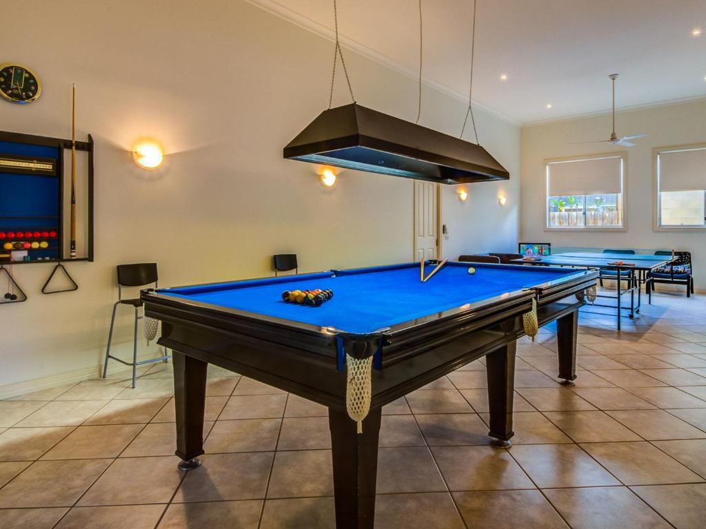 a pool table in a room with several tables at Cuttriss by the Beach in Inverloch