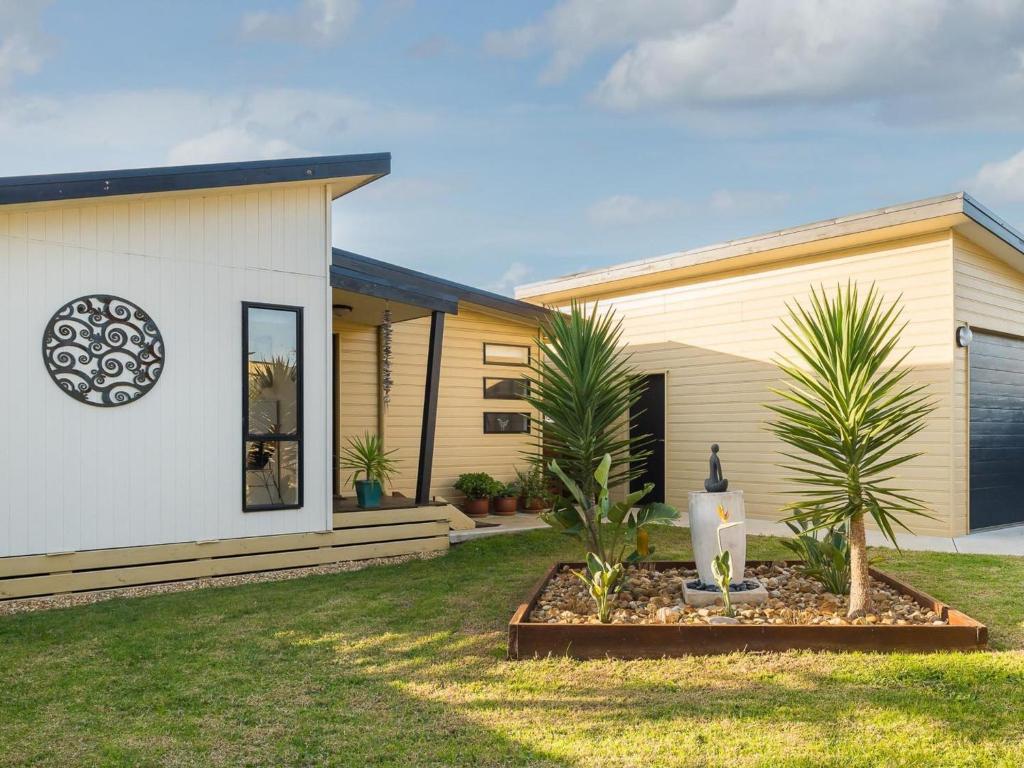 a house with palm trees in front of it at Island Sands in Cowes