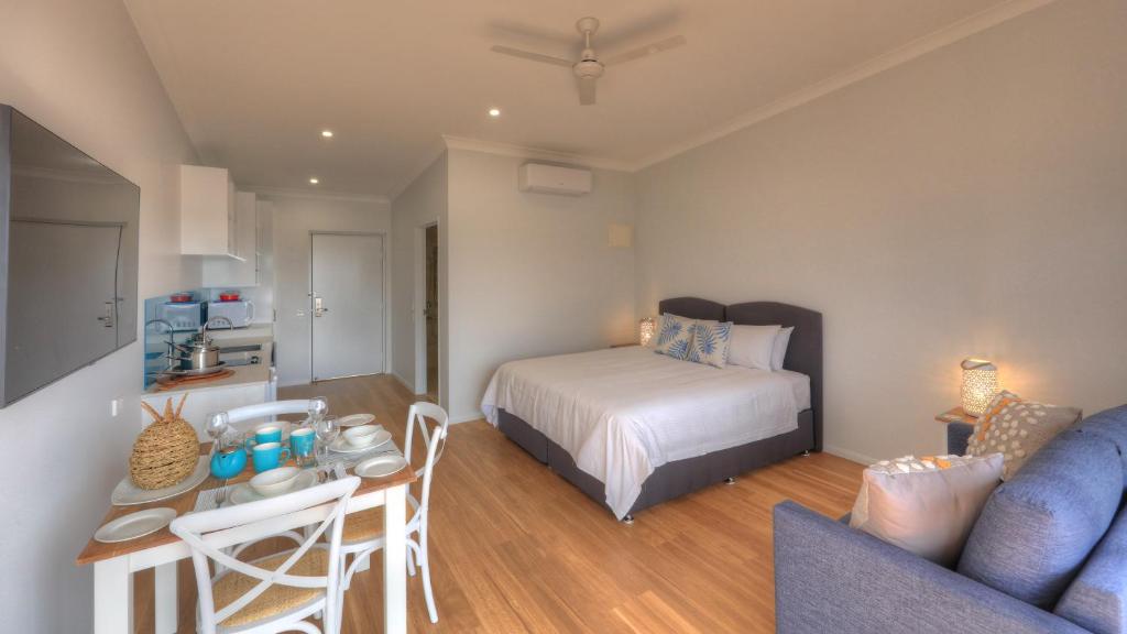 a bedroom with a bed and a table and a couch at Atherton Apartments in Atherton