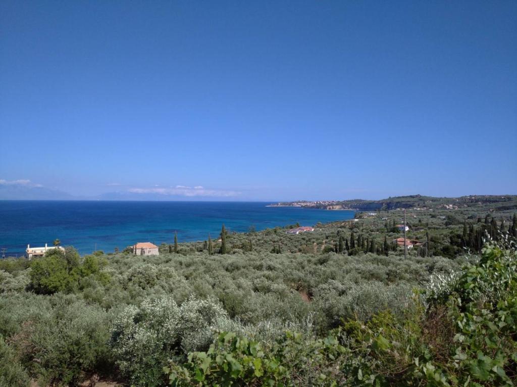 a view of the ocean from the top of a hill at Aggeliki House 3 in Kómboi