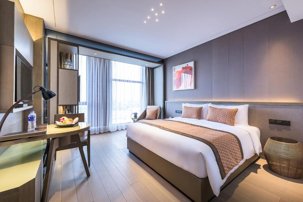 Postel nebo postele na pokoji v ubytování Novotel Shanghai Clover