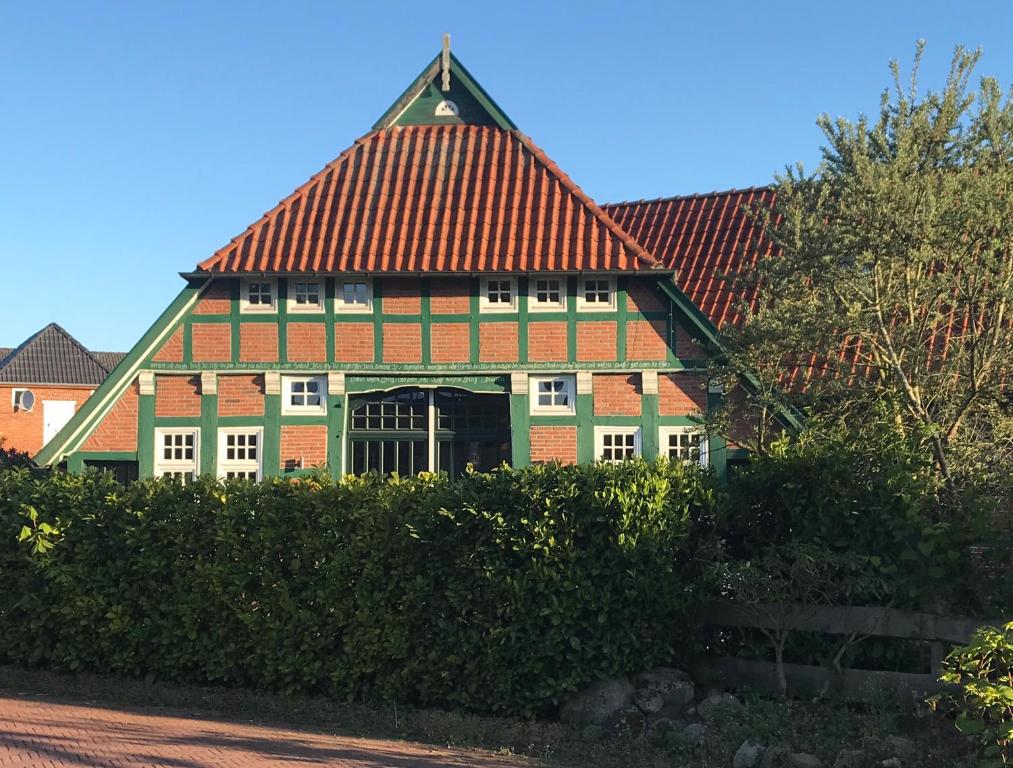 a large house with a red and green roof at Fachwerk-Idyll 1781 in Lemwerder