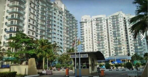 a city with tall buildings and a bus stop at Marina Apartment 3R2B in Kampong Baharu