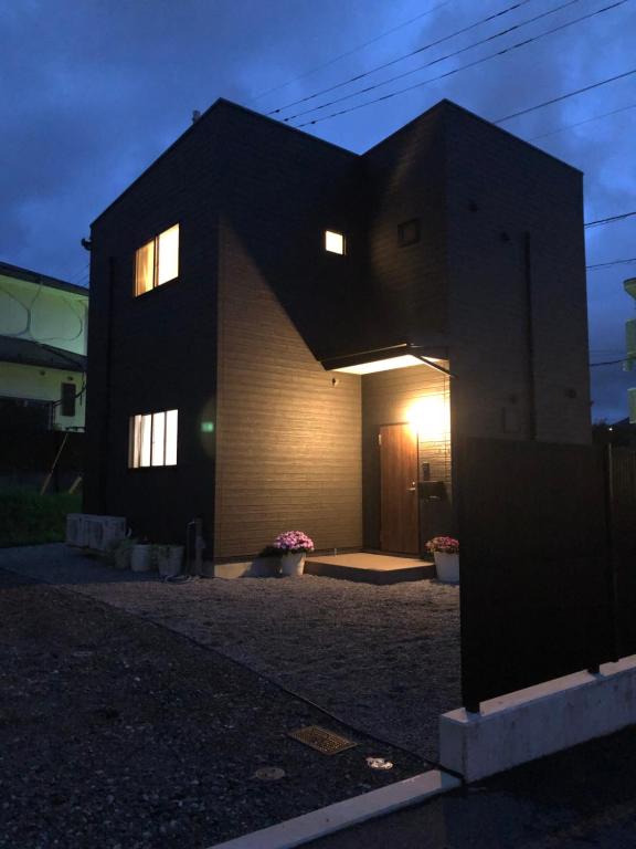 una casa con la luz brillando en su lado en L's Mt.Fuji vacation rental, en Fujikawaguchiko