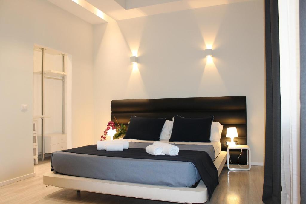 ローマにあるLittle Rose Lodgeのベッドルーム1室(大型ベッド1台、タオル2枚付)