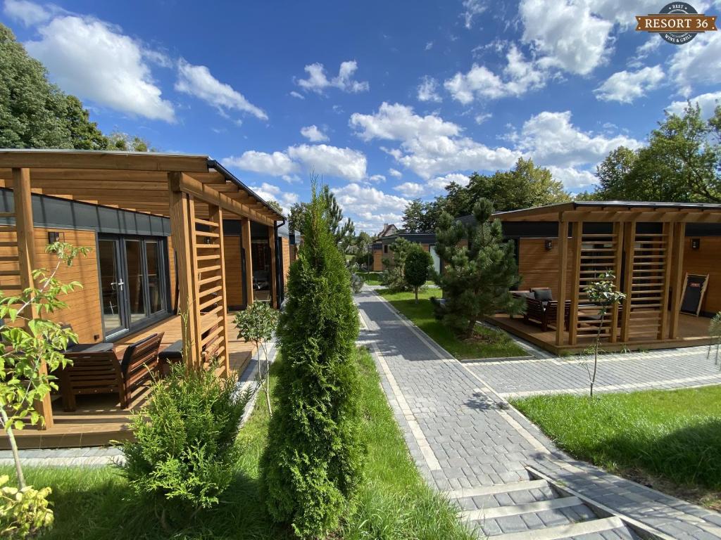 a couple of tiny houses in a park at Resort 36 in Mikołajki