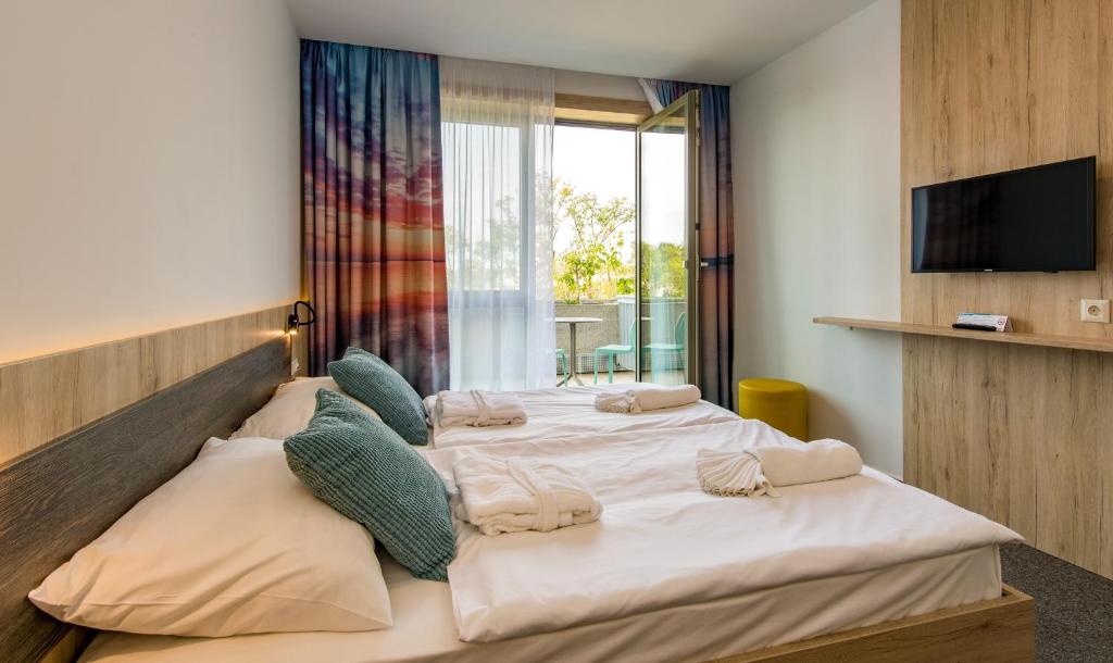 Postel nebo postele na pokoji v ubytování Akadémia Hotel