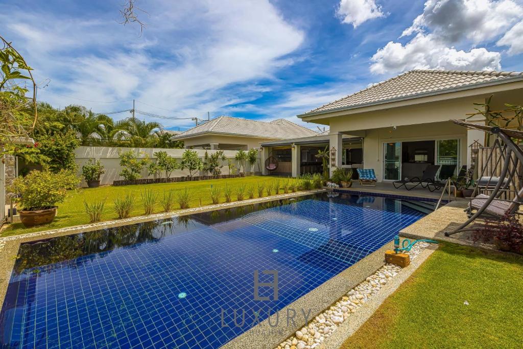 a swimming pool in the backyard of a house at Cozy Modern 3 Bedroom Pool Villa L70 in Hua Hin