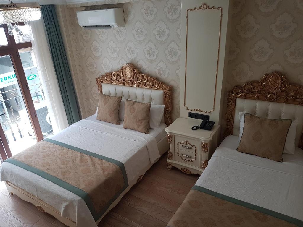 Postel nebo postele na pokoji v ubytování Best Town Hotel