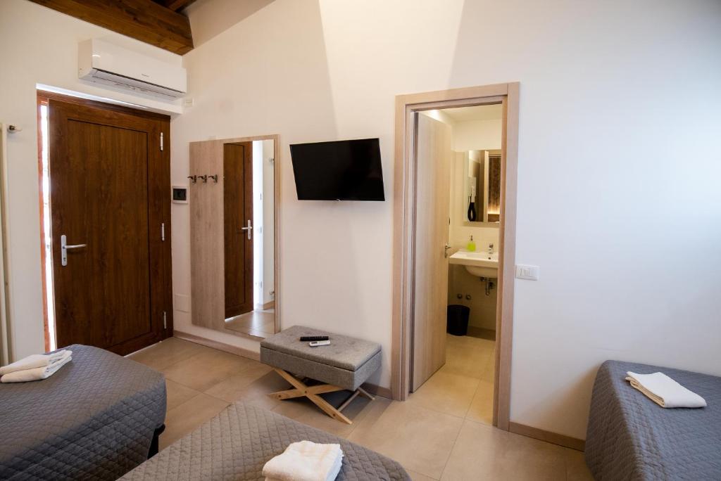 a hotel room with two beds and a mirror at Gu Hotel in Guidonia