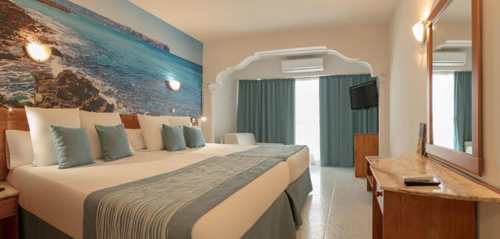 
a hotel room with a large bed and a large window at Magic Cristal Park in Benidorm
