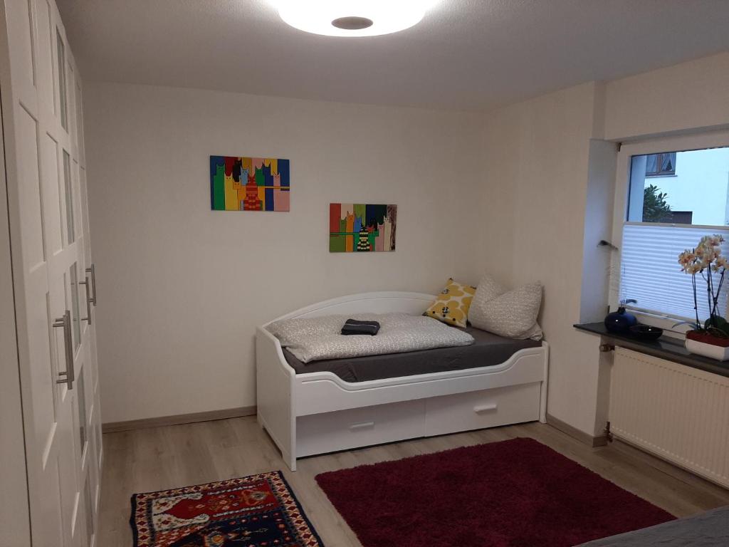 a bedroom with a bed in a room with a window at Ferienwohnung Haus Gards in Marpingen