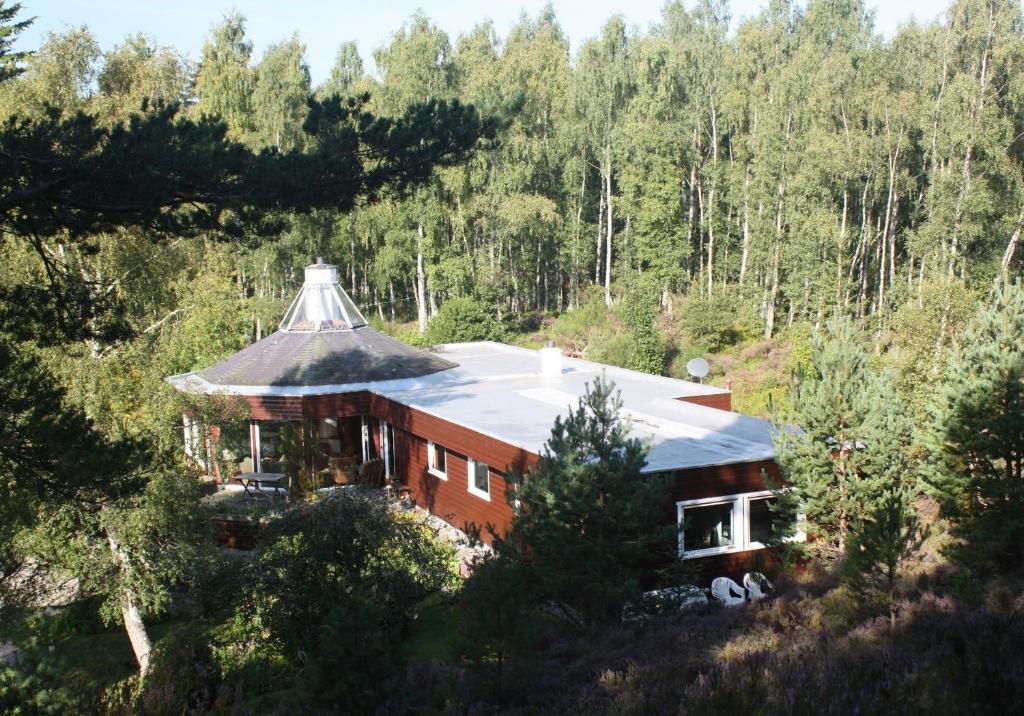 an aerial view of a house in the woods at Cairngorm Lodge Rothiemurchus in Aviemore