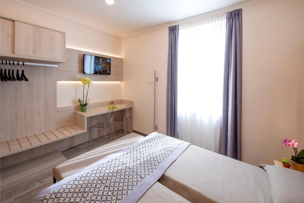 Postel nebo postele na pokoji v ubytování Hotel Sempione
