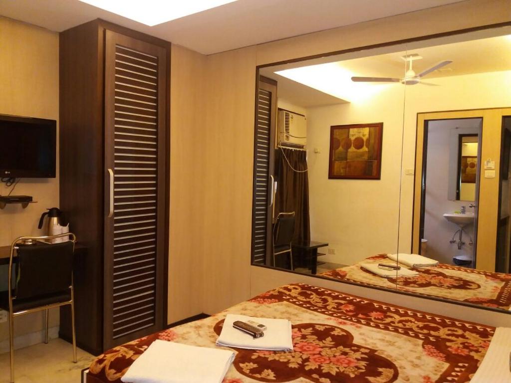 Postel nebo postele na pokoji v ubytování Hotel Esteem