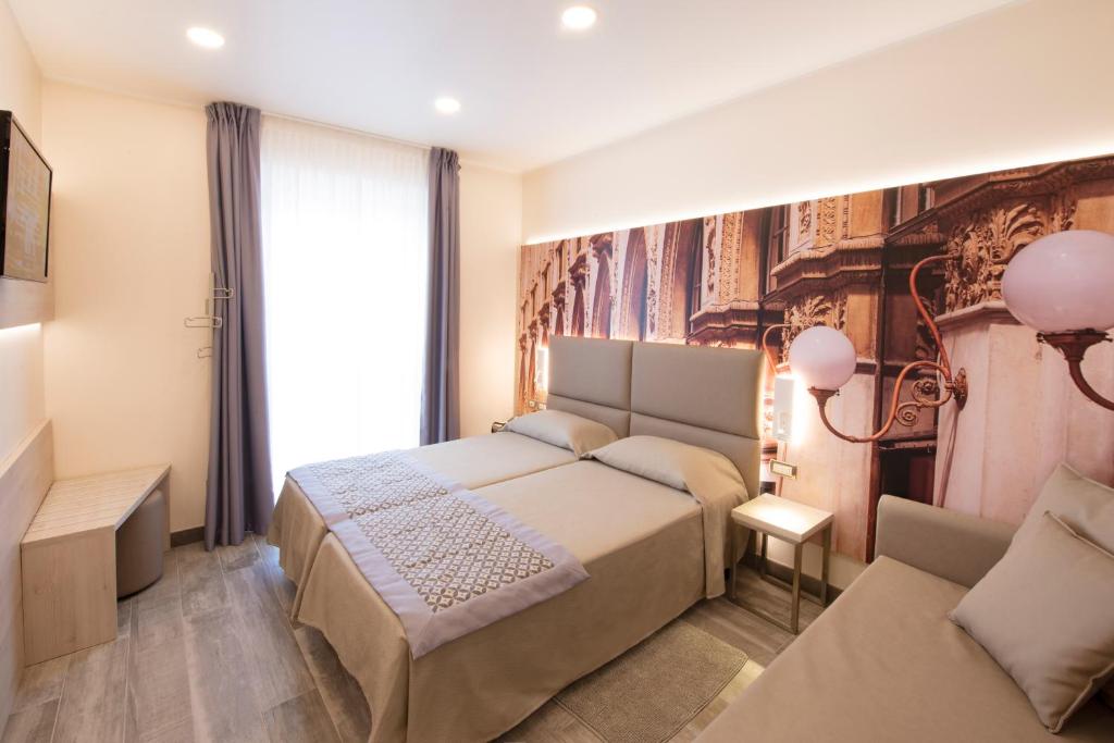 a bedroom with a bed and a large window at Hotel Sempione in Milan