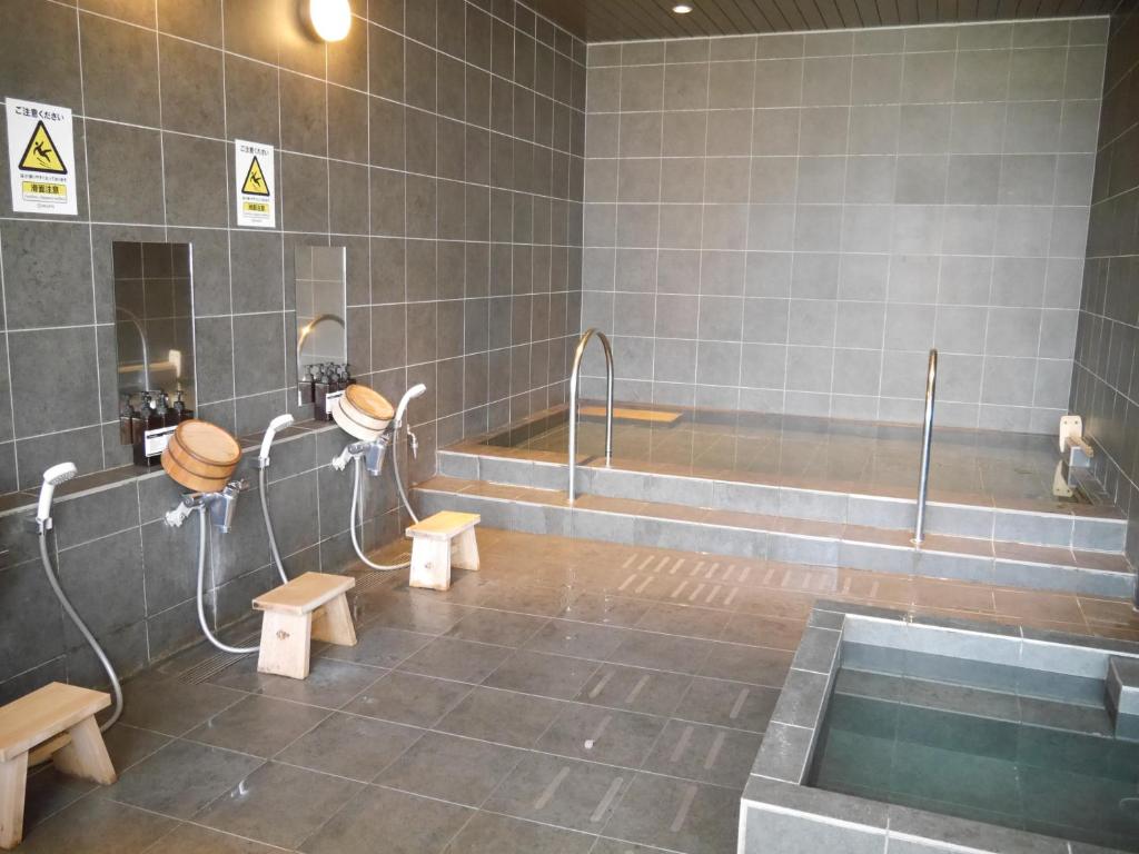 a bathroom with two toilets and a bath tub at HEARTS Capsule Hotel & Spa HAKATA in Fukuoka