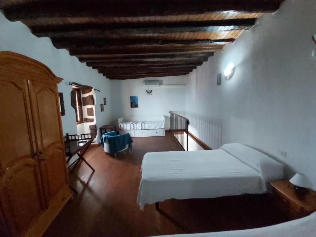 Postel nebo postele na pokoji v ubytování Casa los Abuelos