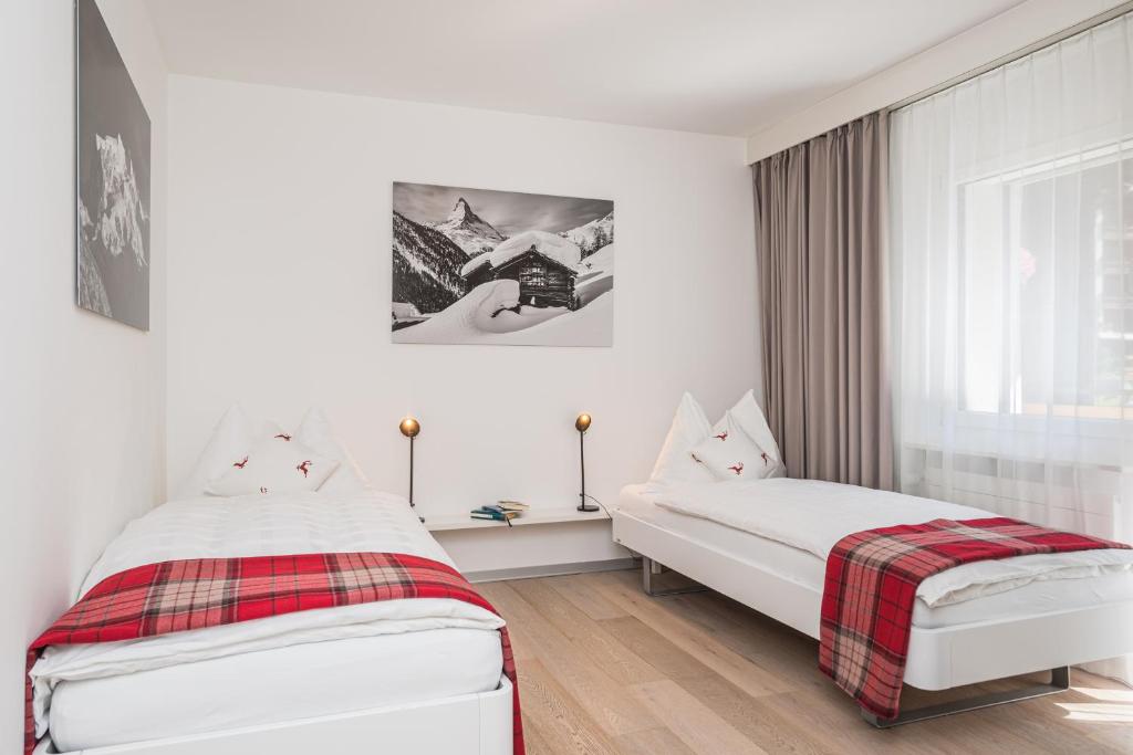Postel nebo postele na pokoji v ubytování Ascot-Zermatt