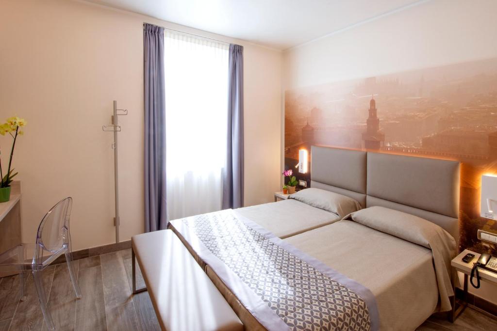 Postel nebo postele na pokoji v ubytování Hotel Sempione