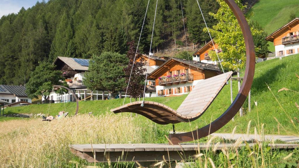 a swinging hammock in front of a house at Familienalm Taser in Schenna