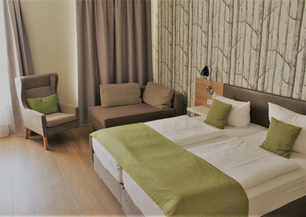 Postel nebo postele na pokoji v ubytování Hotel Eifelbräu