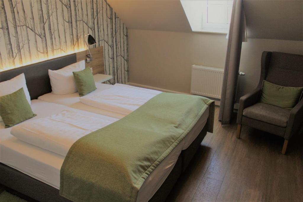 Postel nebo postele na pokoji v ubytování Hotel Eifelbräu