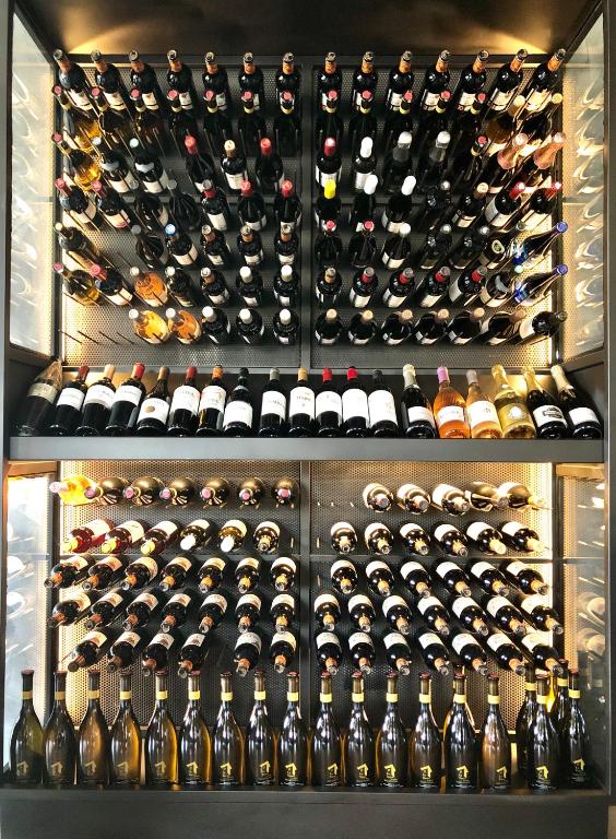 a room with a bunch of bottles of wine at Hotel Gastronómico Torre de Galizano in Galizano