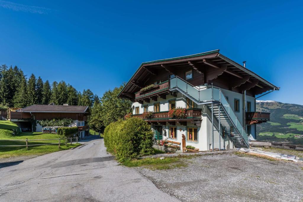 a large building with a staircase on the side of it at Almliesl HOLL-304 in Hollersbach im Pinzgau