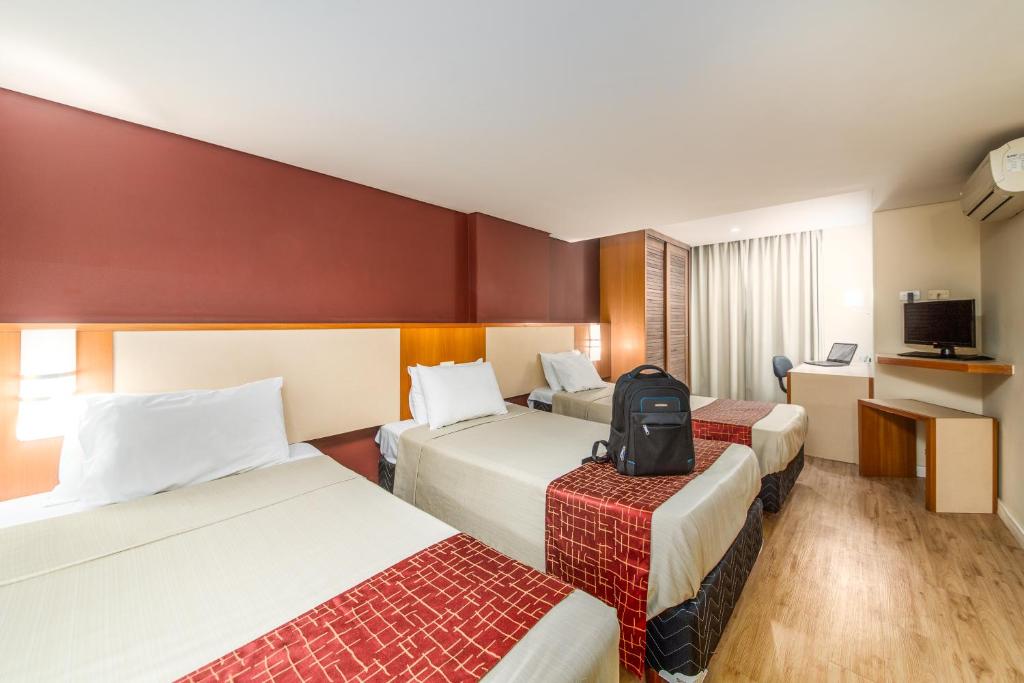 Cama ou camas em um quarto em Rede Andrade CWB