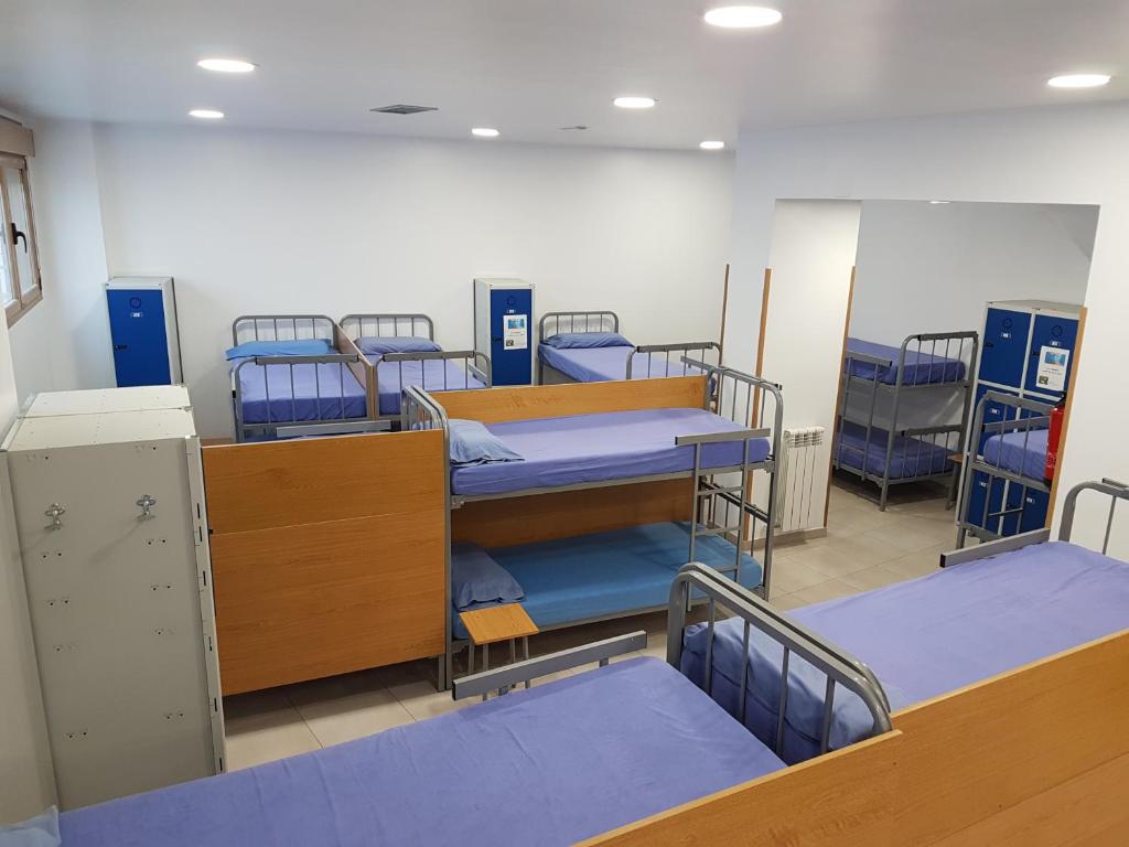 a room with four bunk beds in a hospital at Albergue Albas exclusivo Peregrinos in Logroño