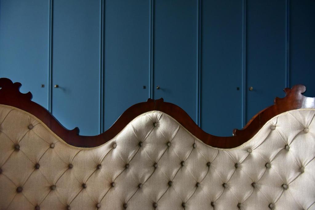 a close up of a couch in front of blue cabinets at The Presidential Suite in Trieste