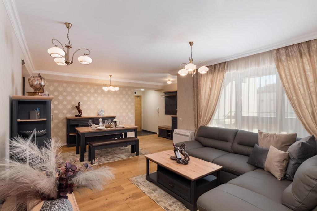 a living room with a couch and a table at Varna Classic Apartments in Varna City