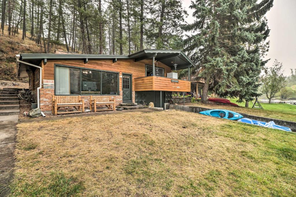 a cabin in the woods with a large yard at Flathead Lake Waterfront Cabin with Dock and Kayaks in Polson